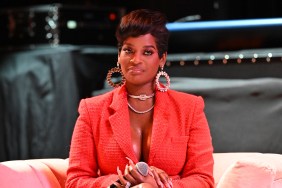 Shamea Morton in a red blazer holding a microphone