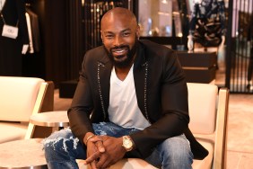 Tyson Beckford sitting in a chair and wearing jeans and a black blazer