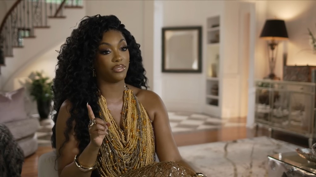 Porsha Williams pointing her finger in a confessional on RHOA Season 16