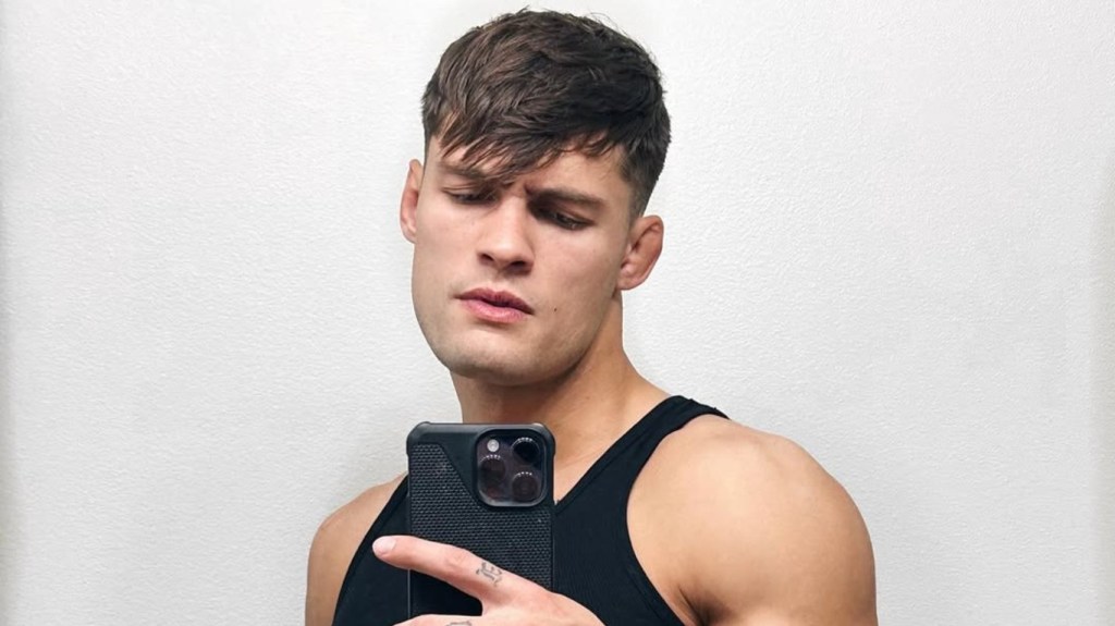 Dylan Geick taking a selfie and wearing a black tank top