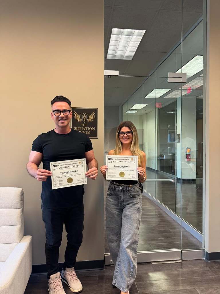 Mike and Lauren Sorrentino showing off their interventionist certifications 
