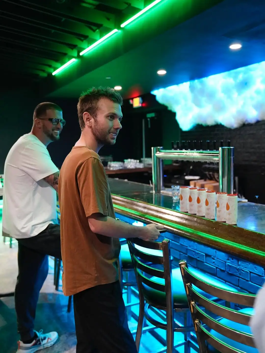 Chase Chrisley standing in front of a bar