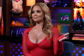 Gizelle Bryant in a red dress holding up her hand in disbelief, while appearing on Watch What Happens Live