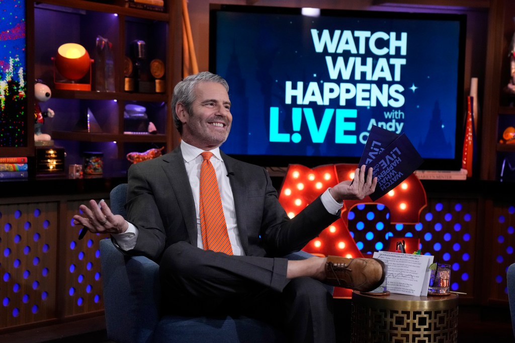 Andy Cohen on Watch What Happens Live shrugging his shoulders
