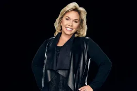 Julie Chrisley posing in front of a black background