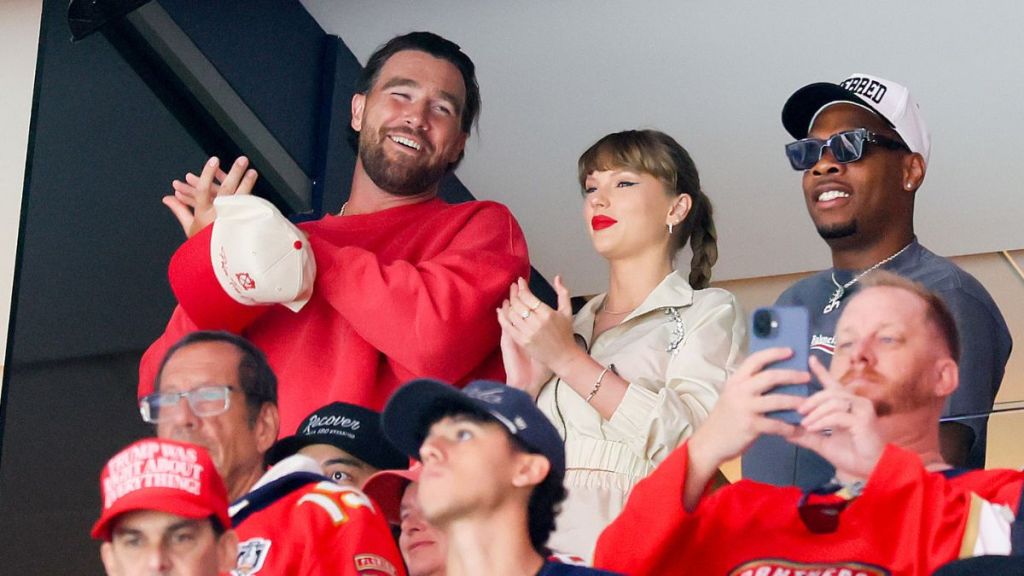 Travis Kelce, left, Taylor Swift and Aric Jones react as the Edmonton Oilers and the Florida Panthers play during the first period in Game Four of the 2025 Stanley Cup Final at Amerant Bank Arena on June 12, 2025 in Sunrise, Florida.
