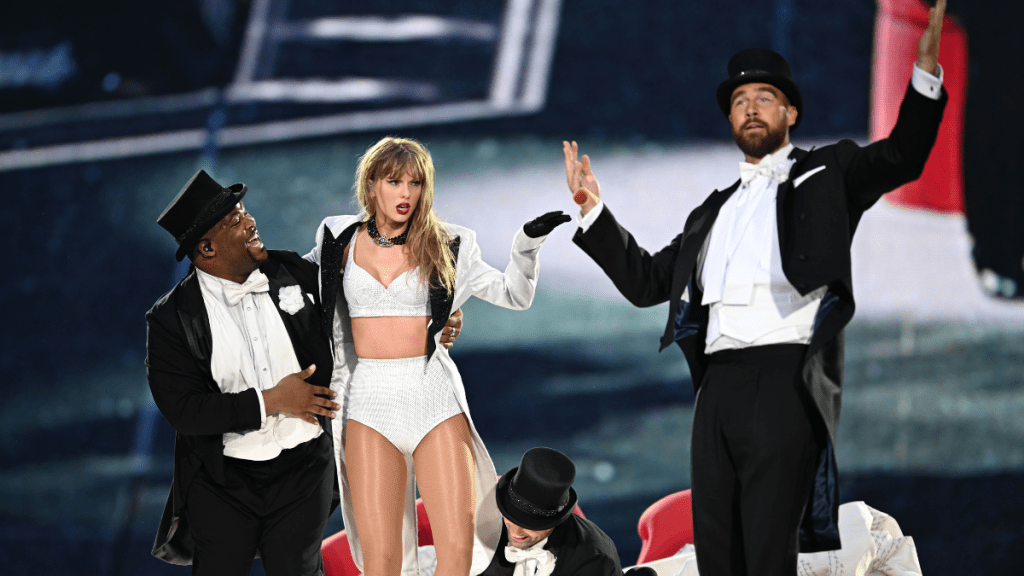 Taylor Swift is joined on stage by Travis Kelce (R), during "Taylor Swift | The Eras Tour" at Wembley Stadium on June 23, 2024 in London, England.