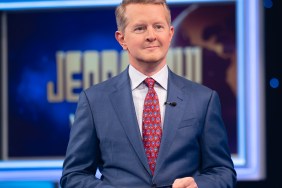 Ken Jennings in a blue suit with a red tie on the set of Jeopardy!