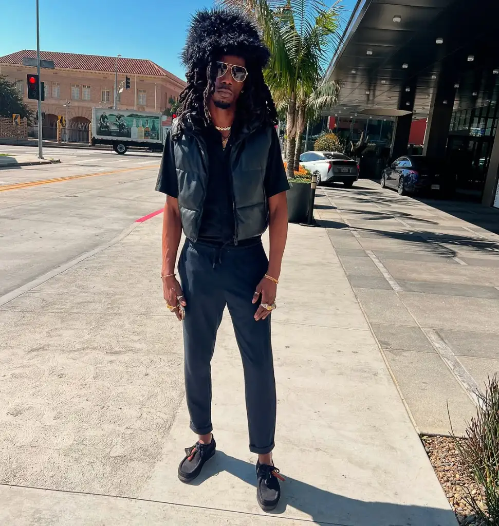 Cynthia Bailey's boyfriend LePrince standing on a street in an all-black outfit
