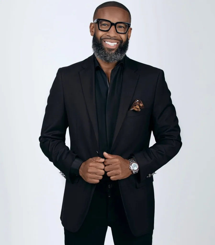Carlos King in a black suit