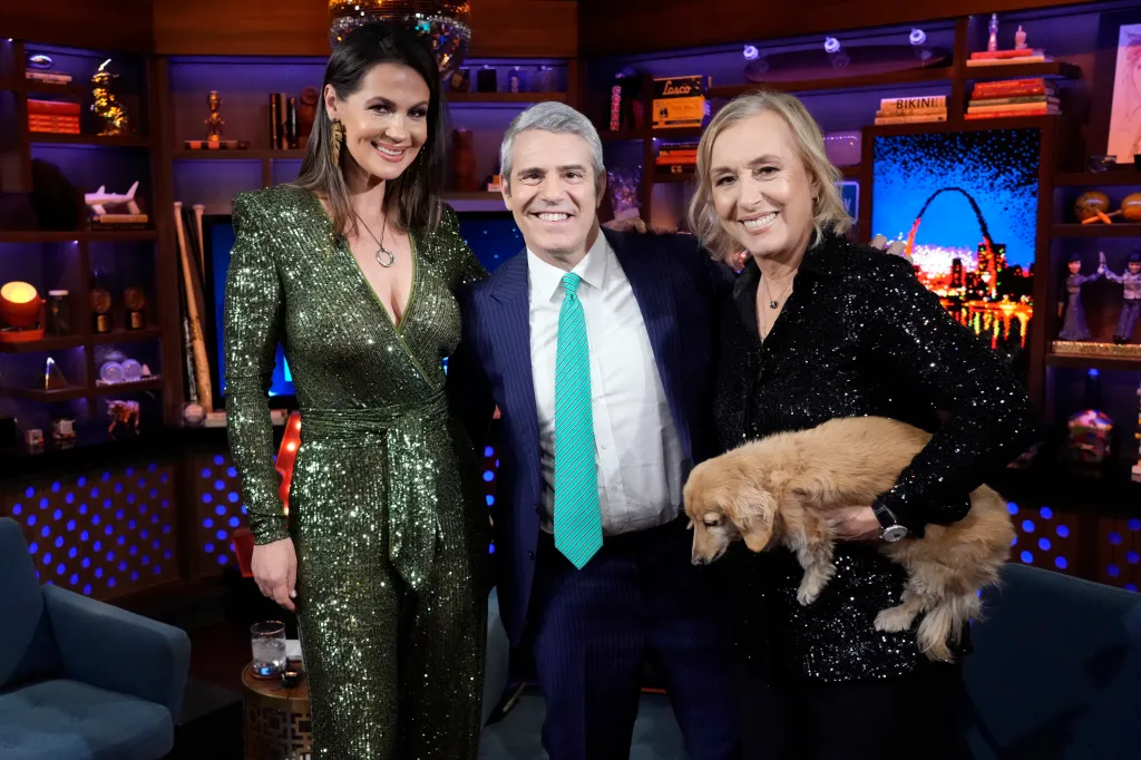 Julia Lemigova, Andy Cohen, and Martina Navratilova at Watch What Happens Live. Martina is holding a dog.