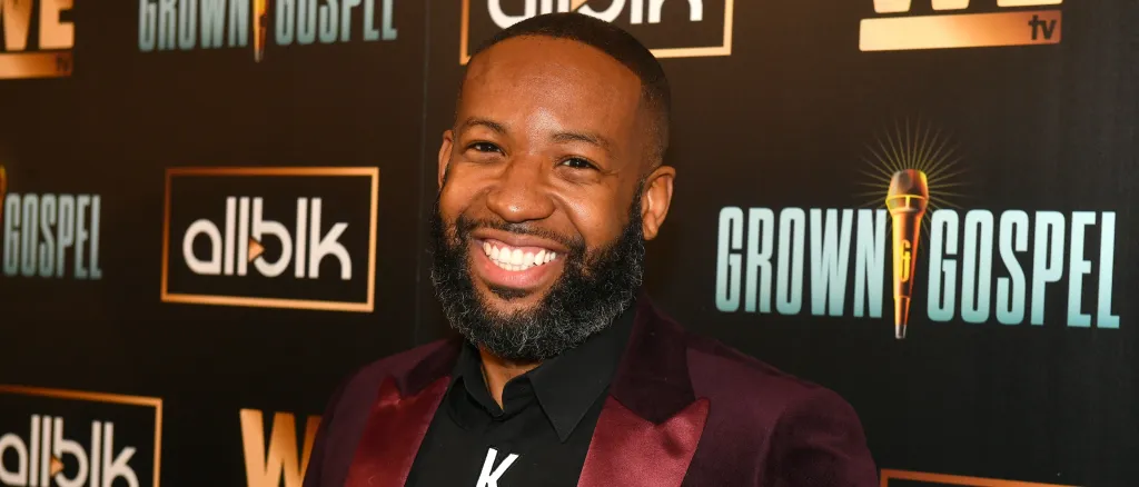 Carlos King in a red suit