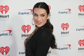 Ashley Iaconetti at iHeartRadio Jingle Ball, wearing black, and doing an over the shoulder pose