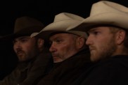 Jesse McBee, Steve McBee, and Cole McBee sitting side by side and wearing cowboy hats