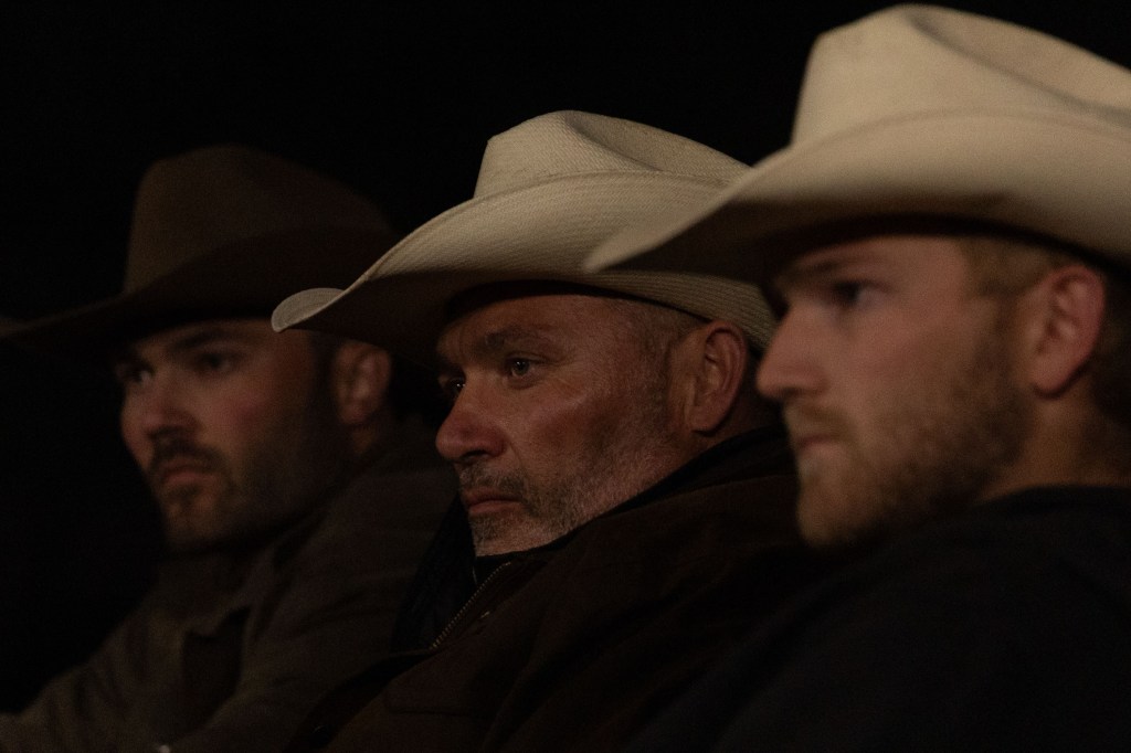 Jesse McBee, Steve McBee, and Cole McBee sitting side by side and wearing cowboy hats
