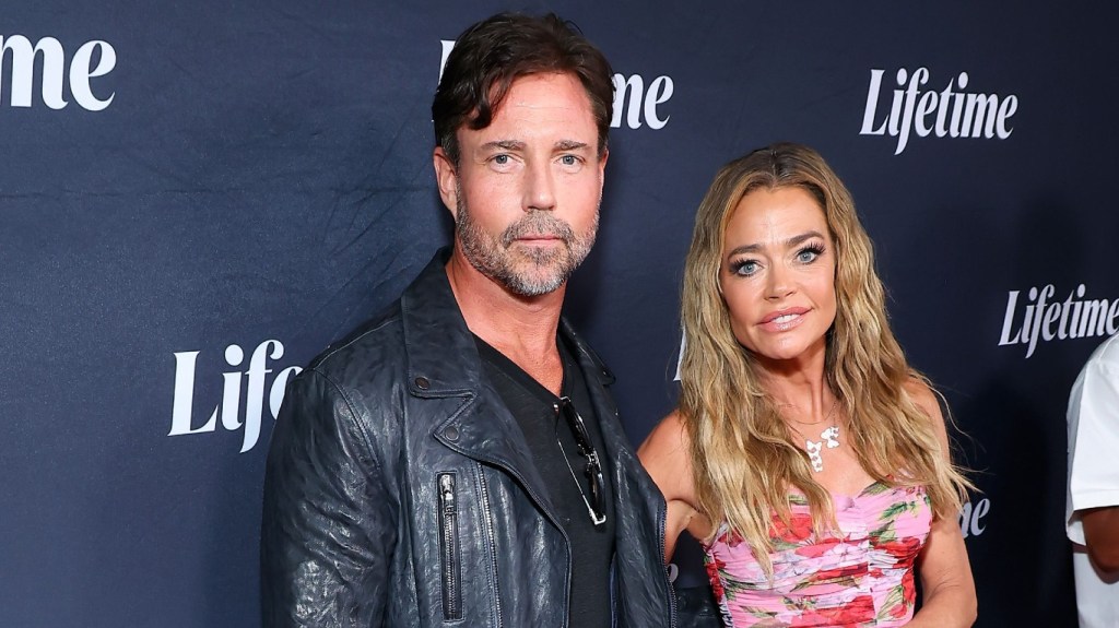 Aaron Phypers and Denise Richards posing on a red carpet
