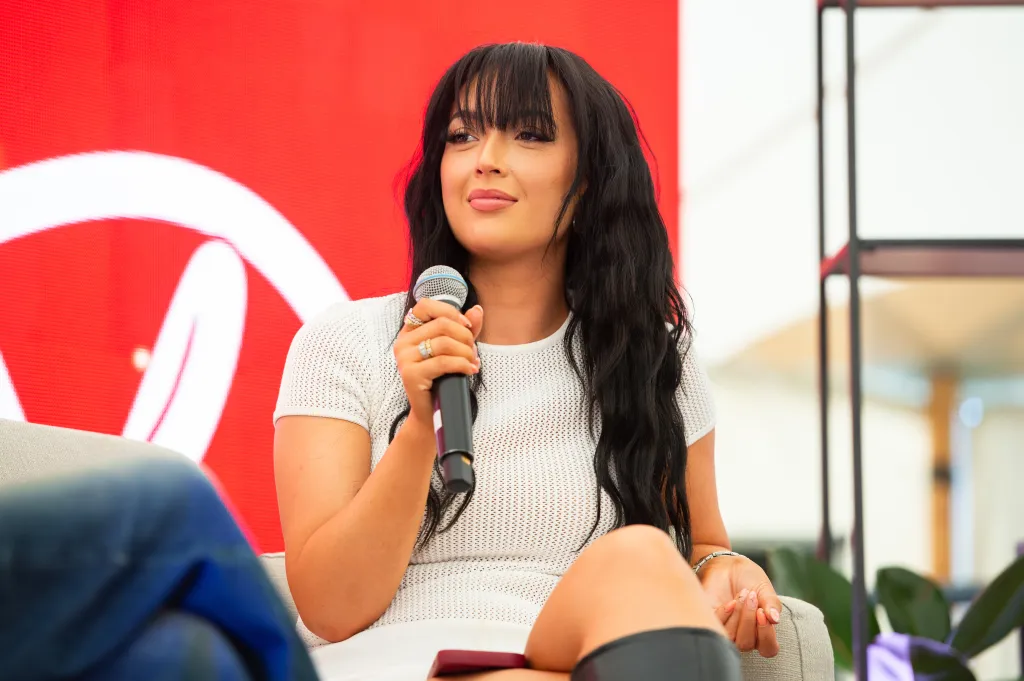 Sharon Gaffka on stage at Reading Festival, holding a microphone