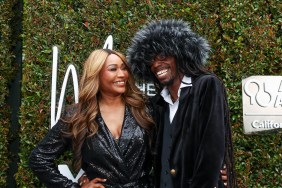 Cynthia Bailey and LePrince waring all black and posing in front of a green backdrop