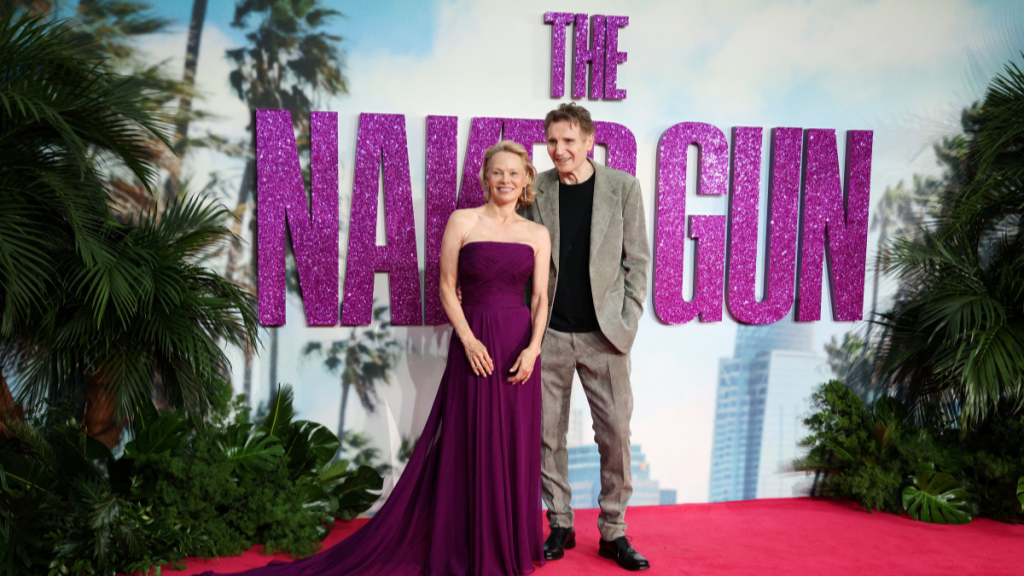 US actress Pamela Anderson (L) and British actor Liam Neeson (R) pose on the red carpet upon arrival for the UK Premier of "Naked Gun" in Leicester Square, central London, on July 22, 2025.