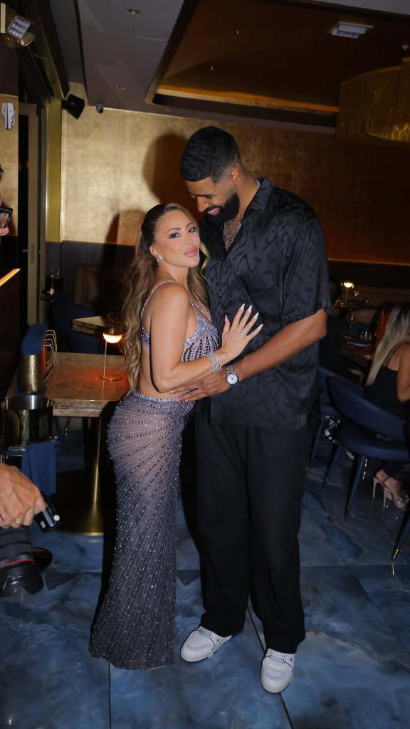 Jeff Coby and Larsa Pippen hugging in the middle of a restaurant 