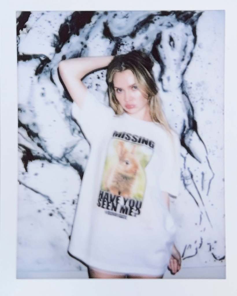 Anna Delvey posing in a white bunnygate t-shirt