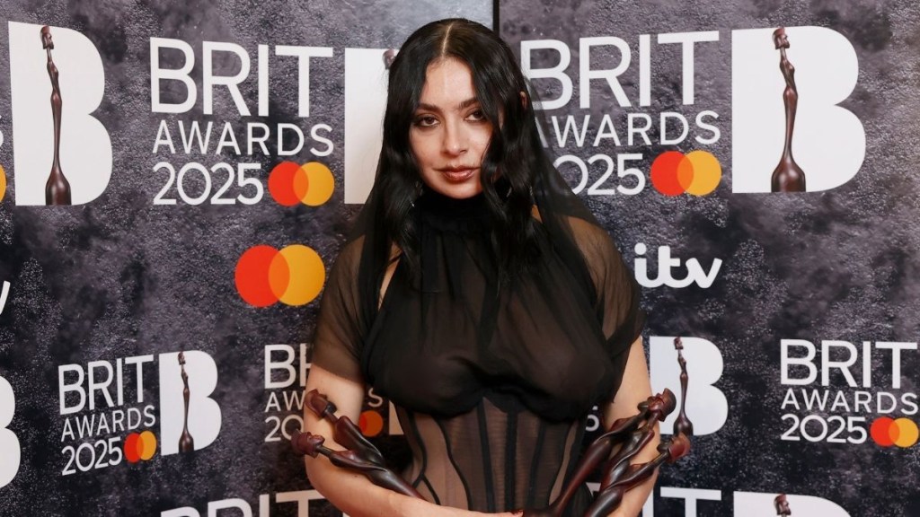 Charli XCX poses in the winners room with the awards for Artist of the Year, Song of the Year, Album of the Year and Dance Act during The BRIT Awards 2025 at The O2 Arena on March 01, 2025 in London, England