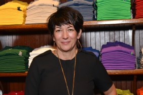 Ghislaine Maxwell standing in front of a colorful rack of Polo shirts