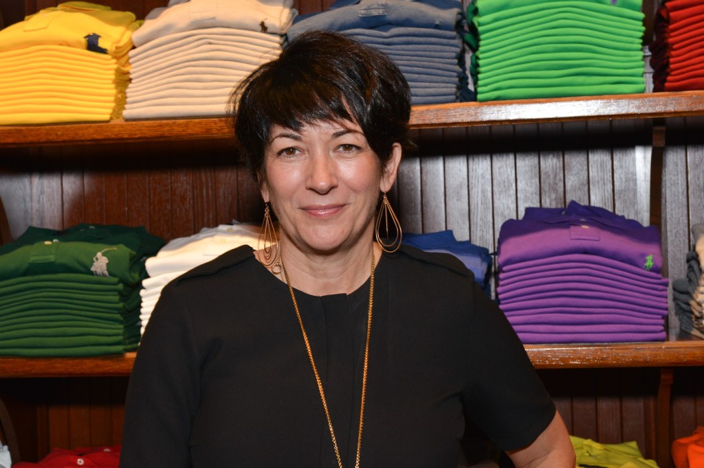 Ghislaine Maxwell standing in front of a colorful rack of Polo shirts