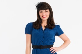 Kenley Collins in a blue dress standing with her hand on her hip for Project Runway Season 5