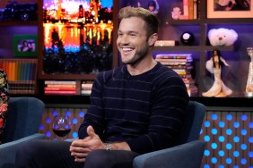 Colton Underwood in a blue sweater smiling on Watch What Happens Live