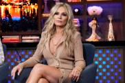 Tamra Judge in a beige dress sitting with her legs crossed on Watch What Happens Live