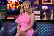 Sonja Morgan in a pink dress looking directly at the camera and smiling on Watch What Happens Live