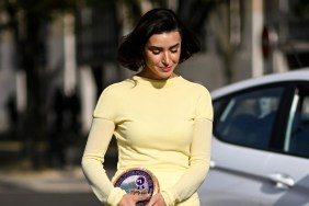 Bronwyn Newport in a yellow dress walking with her head down