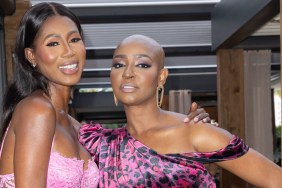 Guerdy Abraira and Kiki Barth posing in pink dresses with their arms around each other