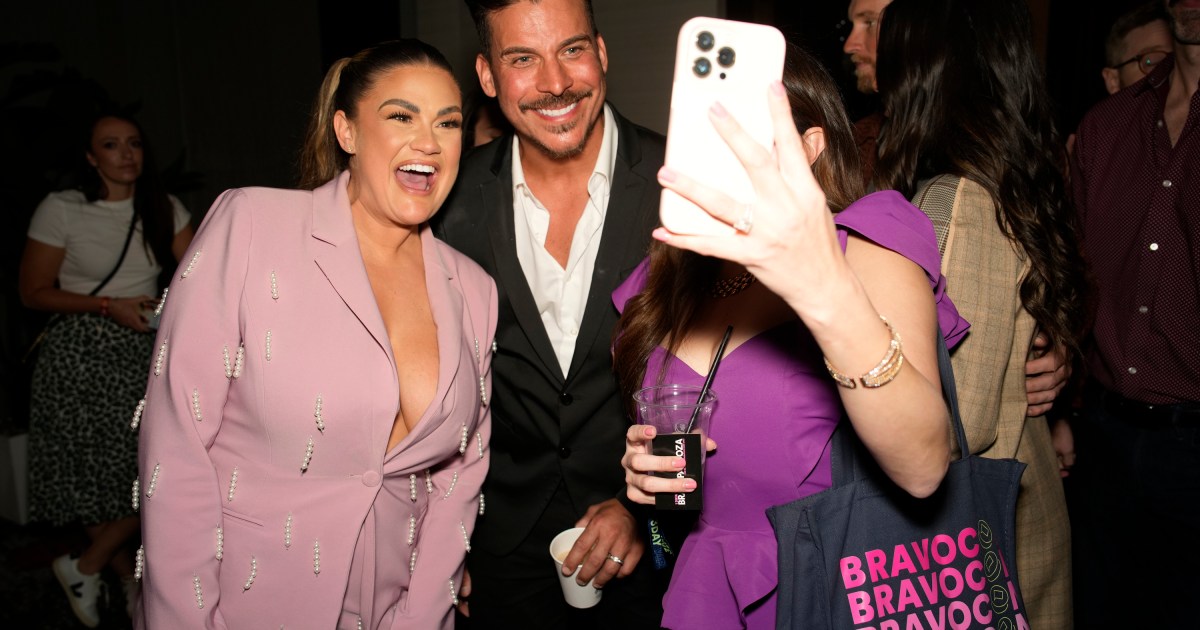 Brittany Cartwright and Jax Taylor taking a selfie with a fan at BravoCon