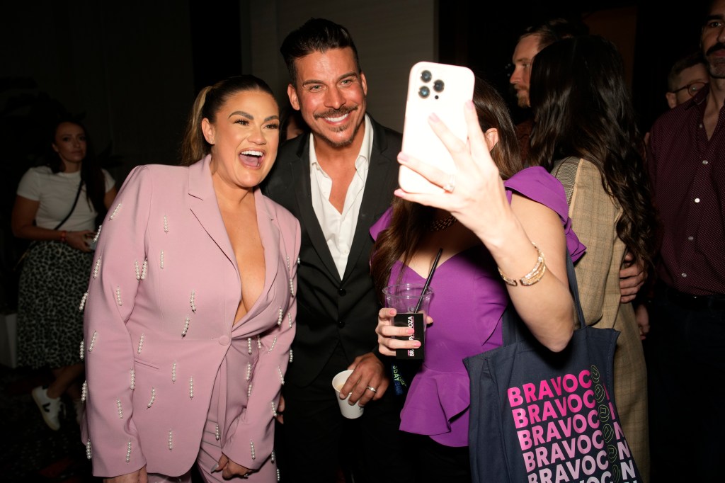 Brittany Cartwright and Jax Taylor taking a selfie with a fan at BravoCon