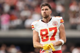 Travis Kelce holding his helmet at a Kansas City Chief's game