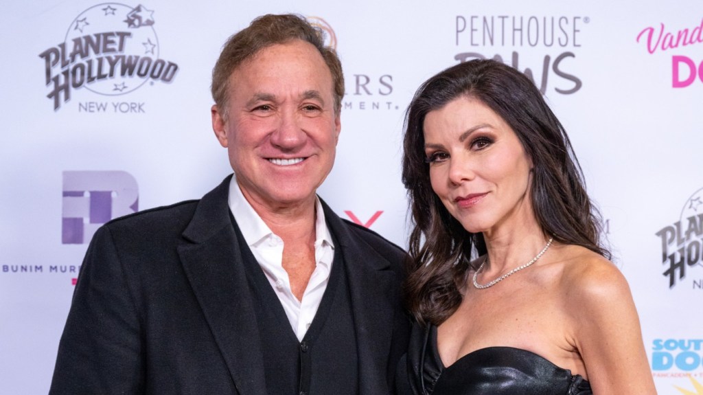 Dr. Terry Dubrow and Heather Dubrow wearing black and posing together on a red carpet
