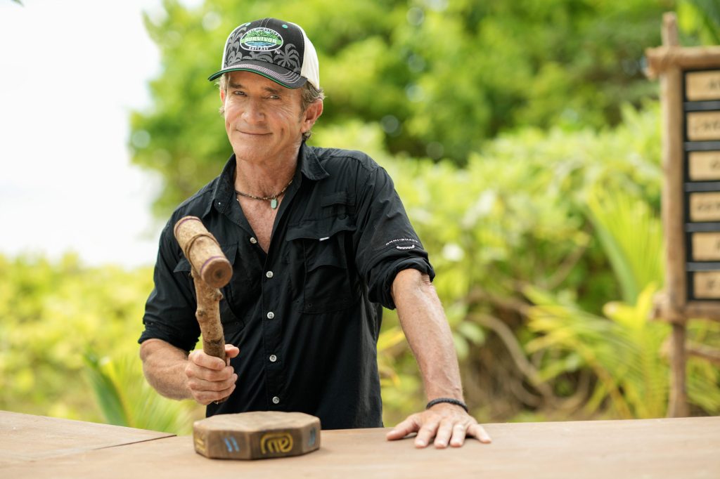 Jeff Probst on Survivor holding a wooden hammer