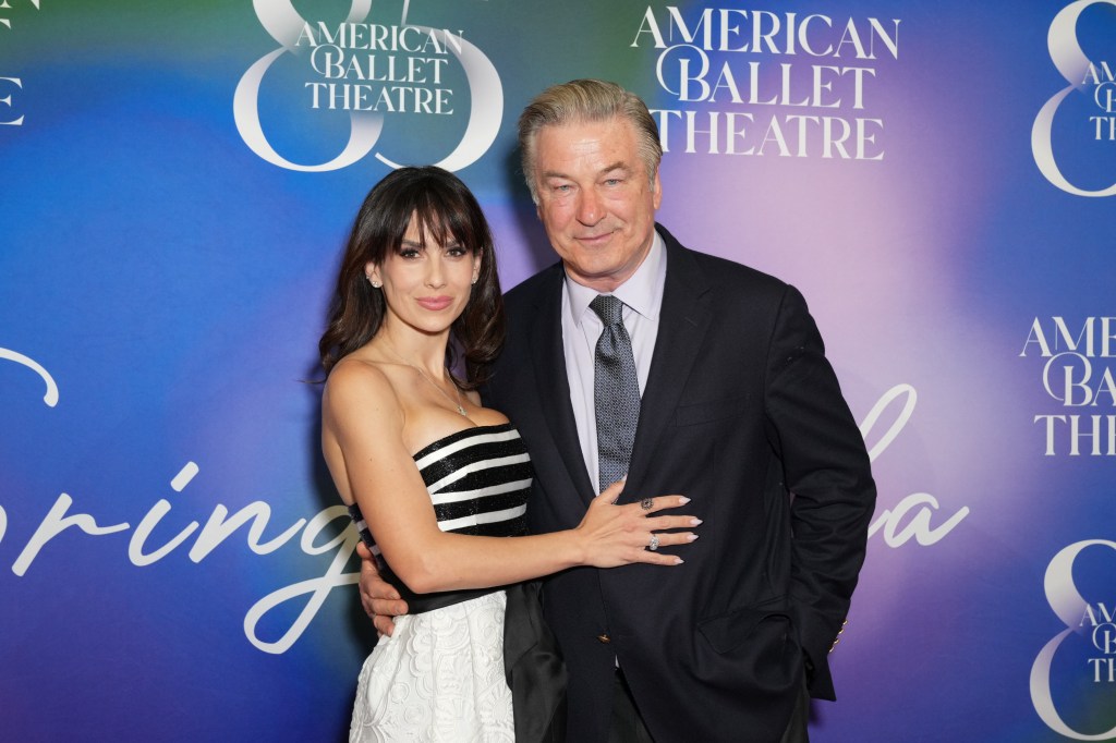 Hilaria Baldwin in a black and white dress posing with Alec Baldwin, who is wearing a black suit, at the American Ballet Theatre
