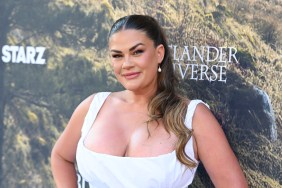Brittany Cartwright in a white dress posing on the red carpet at the premiere of Outlander: Blood of my Blood