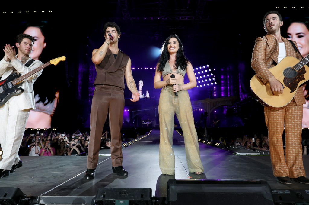 Demi Lovato and the Jonas Brothers on stage at Met Life Stadium