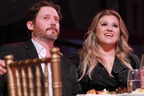 Brandon Blackstock and Kelly Clarkson sitting at a table together at a Billboard event