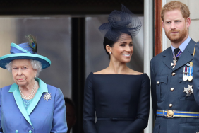 Queen Elizabeth II, Prince Harry, Duke of Sussex and Meghan, Duchess of Sussex on the balcony of Buckingham Palace as the Royal family attend events to mark the Centenary of the RAF on July 10, 2018 in London, England.