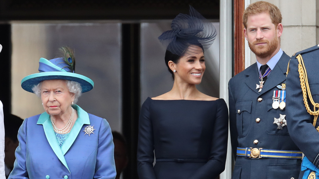 Queen Elizabeth II, Prince Harry, Duke of Sussex and Meghan, Duchess of Sussex on the balcony of Buckingham Palace as the Royal family attend events to mark the Centenary of the RAF on July 10, 2018 in London, England.