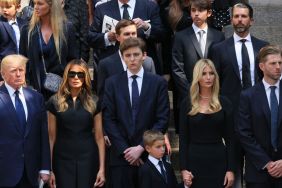 former U.S. President Donald Trump and his wife Melania Trump along with their son Barron Trump and Ivanka Trump, Eric Trump and Donald Trump Jr. and their children watch as the casket of Ivana Trump is put in a hearse outside of St. Vincent Ferrer Roman Catholic Church during her funeral on July 20, 2022 in New York City.