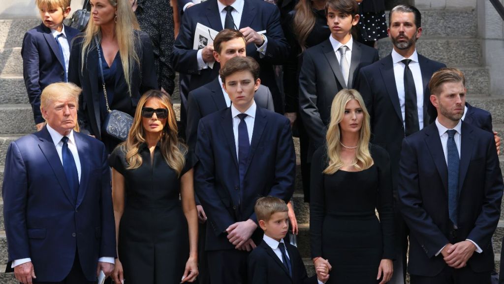 former U.S. President Donald Trump and his wife Melania Trump along with their son Barron Trump and Ivanka Trump, Eric Trump and Donald Trump Jr. and their children watch as the casket of Ivana Trump is put in a hearse outside of St. Vincent Ferrer Roman Catholic Church during her funeral on July 20, 2022 in New York City.