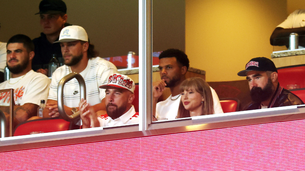 Travis Kelce #87 of the Kansas City Chiefs, Taylor Swift and Jason Kelce watch during the first half of the game between the Cincinnati Bearcats and the Nebraska Cornhuskers at Arrowhead Stadium on August 28, 2025 in Kansas City, Missouri.