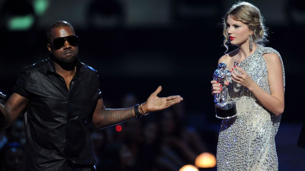 Kanye West takes the microphone from Taylor Swift and speaks onstage during the 2009 MTV Video Music Awards at Radio City Music Hall on September 13, 2009 in New York City