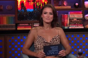 Aesha Scott in a cheetah-print dress on Watch What Happens Live, holding up a note card